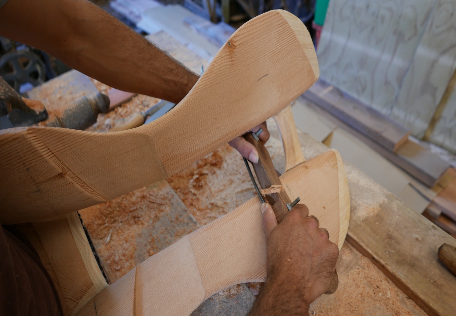 In progress wooden saddle tree being worked on with spoke shave